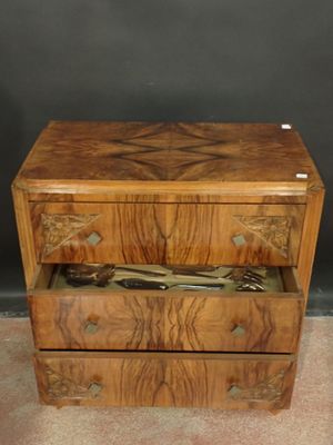 a wooden chest of drawers with a pair of scissors in it