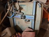 a pile of old appliances in a room with a lot of junk