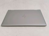 a laptop that is sitting on a white surface
