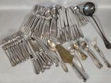 a lot of silver spoons and spoons on the table