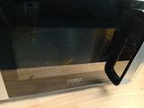 un gros plan d'un micro-ondes posé sur une table en bois