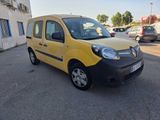 the small yellow van is parked in the parking lot