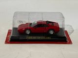 red ferrari 365 gtp diecast car in a glass case