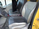 a yellow van with a black seat and a black seat belt