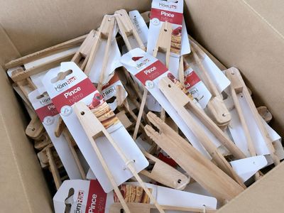 a cardboard box filled with wooden spoons and spatulas