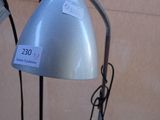 a lamp that is sitting on a table next to a chair