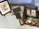 a lot of framed pictures on a table next to a picture