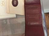 a red wallet sitting on top of a clear box