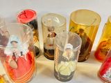 a lot of different colored glass vases sitting on a table