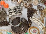 many different types of jewelry on a white table