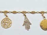 a close up of a gold bracelet with charms on it