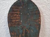 a wooden object that is hanging on the wall