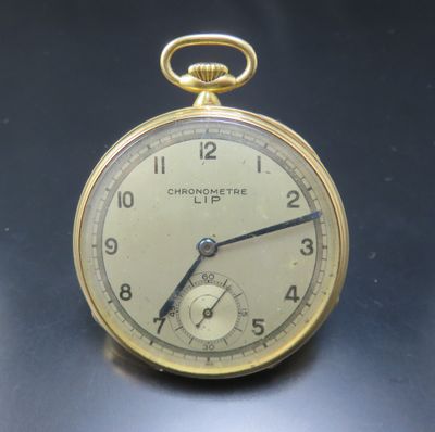 a close up of a pocket watch on a table