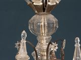 a chandelier with a glass flower on top of it