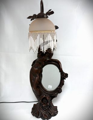a lamp that has a mirror on it and a mirror on the wall