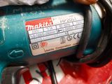 a close up of a hand holding a corded drill