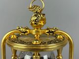 an image of a gold and black hourglass with a dragon on top