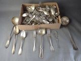 a box full of silver spoons and spoons on a table
