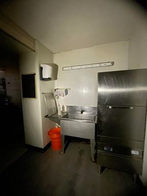 a kitchen with a sink and a refrigerator in it