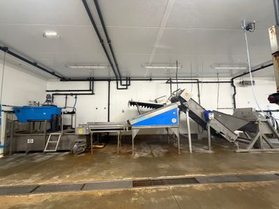 an image of a factory with a conveyor belt in the middle of the room