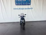 a motorcycle that is parked in front of a sign