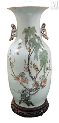 a white vase with a bird and flowers on it