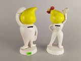 two figurines of a man and a woman with a banana on their head