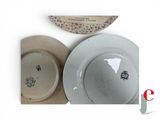 two plates and a bowl sitting on a table