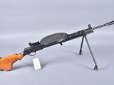 an old machine gun with a wooden handle on a white background
