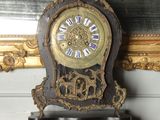 a clock that is sitting on top of a mantle