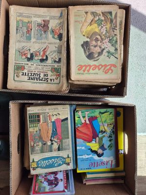 de nombreux livres dans une boîte en carton posée sur une table