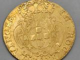 a close up of a gold coin with a crown on it