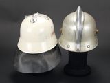 two helmets are sitting on top of each other on a black surface