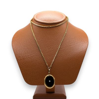 a close up of a necklace on a mannequin on a white background