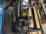 a picture of a drill on a pallet in a garage