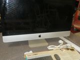 an apple computer sitting on top of a table next to a keyboard