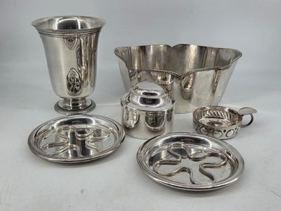 several pieces of silverware on a white table with a white background