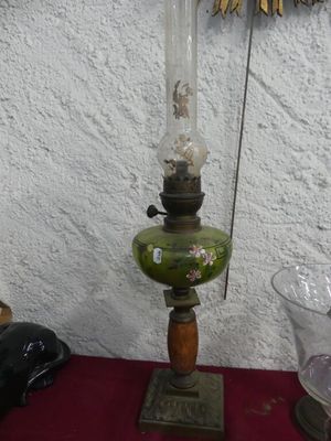 a lamp that is sitting on a table next to a vase