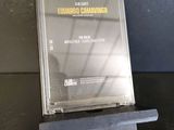 a cd on a stand on a black table