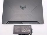 a laptop that is sitting on a table with a charger