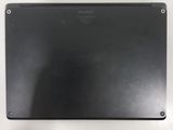 the back of a laptop with a black cover on a white surface