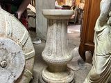 a woman that is standing next to some statues