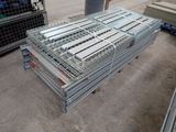 a large pile of metal pallets sitting on the ground
