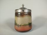 a small jar with a lid on a white table