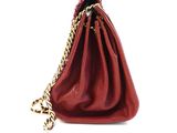 red leather purse with gold chain strap on a white background