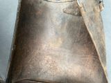 a brown bag sitting on the floor next to a wall