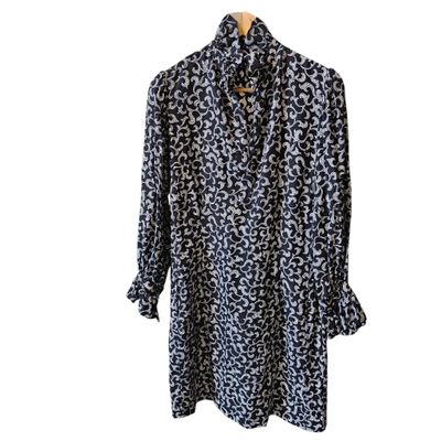 a black and white leopard print shirt on a hanger