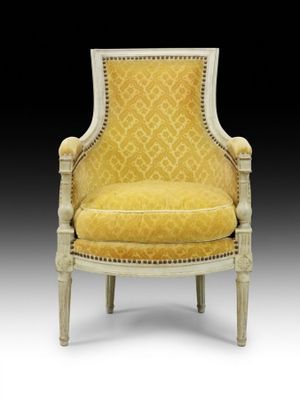 a yellow upholstered chair with a white frame and gold upholstered seat