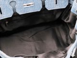a person holding a purse with a zipper on the inside of it