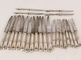 a lot of knives that are sitting on a table